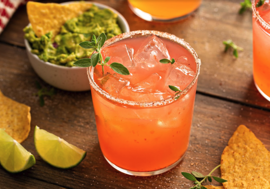 A pink cocktail with chips and guac from Ivy at the Shore, Santa Monica