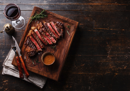 Sliced rare steak and sauce from Meat on Ocean, Santa Monica