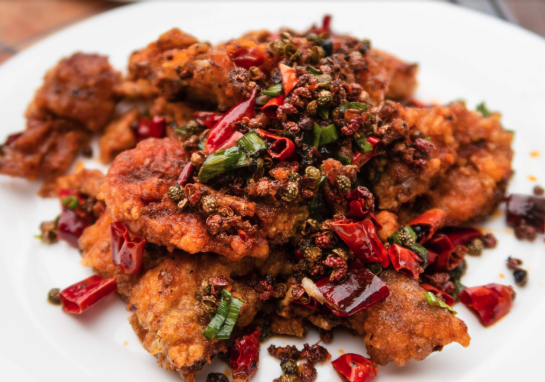 A plate of crispy chicken and peppers from Tar & Roses