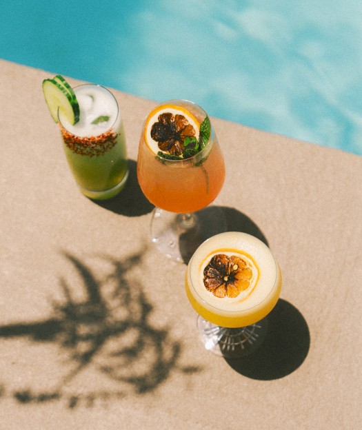 Three cocktails in the sun by the pool